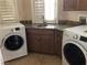 Convenient laundry room with granite countertops, a sink, and a washer and dryer at 768 Tozzetti Ln, Henderson, NV 89012