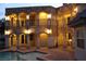 Night view of a house with a pool, courtyard, and outdoor lighting at 768 Tozzetti Ln, Henderson, NV 89012