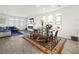 Open dining area with a rustic wooden table and an area rug at 7777 Tempest Sol Ave, Las Vegas, NV 89113