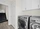 Well-lit laundry room with washer, dryer, and access to stairway at 7777 Tempest Sol Ave, Las Vegas, NV 89113