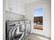 Bright laundry room, featuring LG washer and dryer, and backyard access at 7777 Tempest Sol Ave, Las Vegas, NV 89113