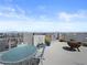 Relaxing rooftop deck with seating, fire pit, and panoramic views at 7777 Tempest Sol Ave, Las Vegas, NV 89113