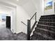 Modern staircase with dark wood railings and carpet runner at 7777 Tempest Sol Ave, Las Vegas, NV 89113