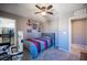 Bright bedroom with striped bedding and walk-in closet at 8034 Mercury Skye St, Las Vegas, NV 89166