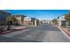 Gated entrance to the community with paved road and landscaping at 8034 Mercury Skye St, Las Vegas, NV 89166