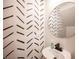 Stylish powder room with black and white patterned wallpaper at 8034 Mercury Skye St, Las Vegas, NV 89166