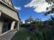 Landscaped backyard with covered patio and artificial turf at 8157 Lennox View Ln, Las Vegas, NV 89113