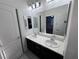 Double vanity bathroom with updated fixtures and a large mirror at 8157 Lennox View Ln, Las Vegas, NV 89113