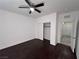 Simple bedroom with dark floors and ceiling fan at 8157 Lennox View Ln, Las Vegas, NV 89113