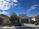 Single-story home with a two-car garage and well-manicured landscaping at 8157 Lennox View Ln, Las Vegas, NV 89113