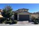 Two story home with a two car garage and landscaping at 8157 Lennox View Ln, Las Vegas, NV 89113