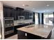 Spacious kitchen with dark cabinetry, granite countertops, and stainless steel appliances at 8157 Lennox View Ln, Las Vegas, NV 89113