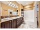 Double vanity bathroom with dark wood cabinets and tile flooring at 8477 Orly Ave, Las Vegas, NV 89143