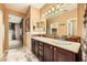 Double vanity bathroom with dark wood cabinets and tile flooring at 8477 Orly Ave, Las Vegas, NV 89143