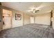 Spacious bedroom with ceiling fan, carpet flooring, and ensuite bathroom access at 8477 Orly Ave, Las Vegas, NV 89143