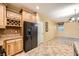 Spacious kitchen with light wood cabinets, granite counters, and black appliances at 8477 Orly Ave, Las Vegas, NV 89143