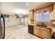 Kitchen with wood cabinets, black appliances, and granite countertops at 8477 Orly Ave, Las Vegas, NV 89143