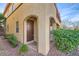 Side entrance with brown door and landscaping at 8477 Orly Ave, Las Vegas, NV 89143