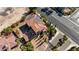 Stunning aerial view of terracotta-roofed home with solar panels in a lush, gated community at 8490 Via De Bellasidra Ct, Las Vegas, NV 89123