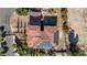 Overhead view of a terracotta-roofed home with solar panels and lush desert landscaping at 8490 Via De Bellasidra Ct, Las Vegas, NV 89123