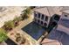 Aerial view of the backyard with patio, balconies, and surrounding landscape at 8490 Via De Bellasidra Ct, Las Vegas, NV 89123