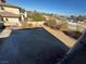 Large backyard with desert landscaping and partial view of neighboring homes at 8490 Via De Bellasidra Ct, Las Vegas, NV 89123