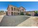 Expansive backyard showcases the home's two-story exterior with balconies and a detached garage at 8490 Via De Bellasidra Ct, Las Vegas, NV 89123