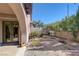 Landscaped backyard with gravel, mature plants and access to home at 8490 Via De Bellasidra Ct, Las Vegas, NV 89123