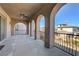 Spacious balcony with arched openings offers panoramic views of the surrounding landscape at 8490 Via De Bellasidra Ct, Las Vegas, NV 89123