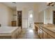 Large bathroom featuring a tiled shower, double vanity, and soaking tub at 8490 Via De Bellasidra Ct, Las Vegas, NV 89123