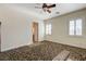 Bright bedroom featuring a ceiling fan, neutral walls, plantation shutters, and patterned carpeting at 8490 Via De Bellasidra Ct, Las Vegas, NV 89123