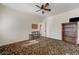 Spacious bedroom with patterned carpet, providing comfort and style, alongside a small bar table at 8490 Via De Bellasidra Ct, Las Vegas, NV 89123