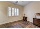 Bedroom with wood floors, plantation shutters, decorative lamps, and neutral walls at 8490 Via De Bellasidra Ct, Las Vegas, NV 89123