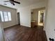 Bedroom with hardwood floors, ceiling fan, and access to bathroom at 8490 Via De Bellasidra Ct, Las Vegas, NV 89123