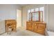 Bedroom with a wooden vanity, plush carpet, plantation shutters, and a view of a neighboring bathroom at 8490 Via De Bellasidra Ct, Las Vegas, NV 89123