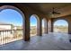 Large covered patio with arched columns, offering ample space and views of the surrounding landscape at 8490 Via De Bellasidra Ct, Las Vegas, NV 89123