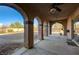 Spacious covered patio with ceiling fans and arched columns, perfect for outdoor living and entertaining at 8490 Via De Bellasidra Ct, Las Vegas, NV 89123