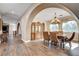 Elegant dining room featuring a chandelier, wood floors, large windows, and a decorative hutch at 8490 Via De Bellasidra Ct, Las Vegas, NV 89123