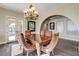 Elegant dining room featuring a decorative chandelier and plenty of natural light at 8490 Via De Bellasidra Ct, Las Vegas, NV 89123