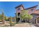 Elegant home with a stone facade, balcony, and mature landscaping at 8490 Via De Bellasidra Ct, Las Vegas, NV 89123