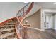 Entryway features curved staircase, decorative iron railing and wood-look tile floors at 8490 Via De Bellasidra Ct, Las Vegas, NV 89123