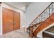 Elegant foyer with wood-look tile flooring, staircase, and decorative front doors at 8490 Via De Bellasidra Ct, Las Vegas, NV 89123