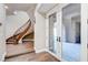 Grand foyer featuring a curved staircase, hardwood flooring, and double glass doors leading to a patio at 8490 Via De Bellasidra Ct, Las Vegas, NV 89123