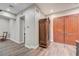 Hallway with wood floors, double doors, and an antique armoire at 8490 Via De Bellasidra Ct, Las Vegas, NV 89123