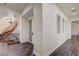 Hallway featuring a curved staircase, iron railings, and wood flooring at 8490 Via De Bellasidra Ct, Las Vegas, NV 89123