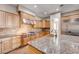 Close-up of the gourmet kitchen featuring granite countertops, stainless steel hood, and custom cabinets at 8490 Via De Bellasidra Ct, Las Vegas, NV 89123