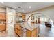 Gourmet kitchen with granite counters, stainless appliances, and an island with a farmhouse sink at 8490 Via De Bellasidra Ct, Las Vegas, NV 89123