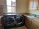 Laundry room with LG washer and dryer, and a utility sink at 8490 Via De Bellasidra Ct, Las Vegas, NV 89123