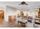 Open-concept living room featuring hardwood floors, decorative archways, and a cozy seating area at 8490 Via De Bellasidra Ct, Las Vegas, NV 89123