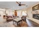 Spacious living room featuring hardwood floors, neutral walls, a fireplace, and leather furniture at 8490 Via De Bellasidra Ct, Las Vegas, NV 89123